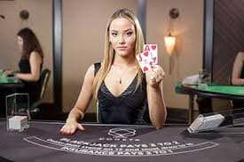 Live Sic Bo dealer rolling dice in professional studio with multiple camera angles